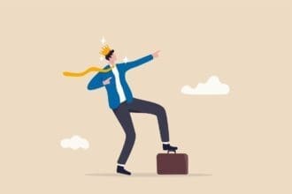 Businessman with crown balancing leadership concept