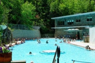 Visitors enjoy the tranquil Radium Hot Springs pool in British Columbia, summer setting.