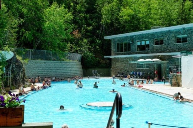 Visitors enjoy the tranquil Radium Hot Springs pool in British Columbia, summer setting.