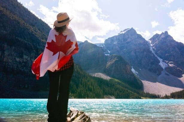 Woman with Canadian flag by scenic mountain lake