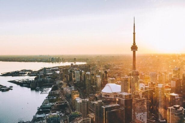 Sunset over waterfront cityscape with towering skyline.