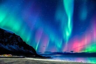 Vibrant Aurora Borealis display over Icelands night sky.
