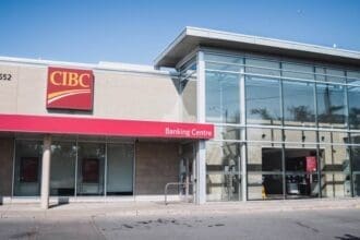 Modern CIBC bank branch exterior with clear sky.