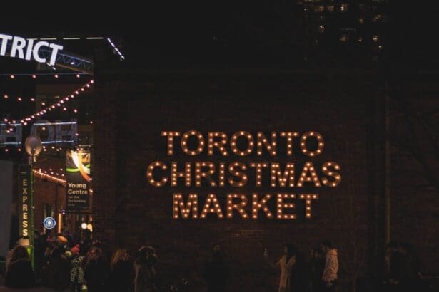 Illuminated Toronto Christmas Market sign at night.