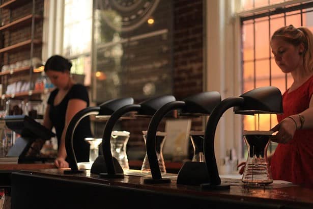 Vibrant Vancouver bar scene with patrons and staff.