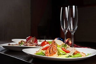 Tasty shrimp salad with vegetables on a table