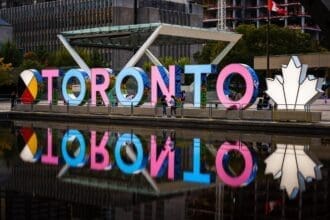 Colorful Toronto sign with reflection in water.