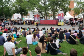 Outdoor audience enjoying a live performance at Edmonton Fringe Festival.