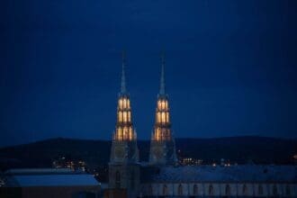Illuminated church spires at night in Ottawa.