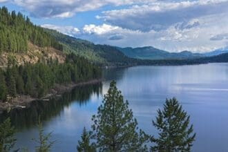 Scenic view of Christina Lake with trees in British Columbia, Canada.