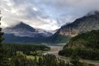 Breathtaking view of misty mountains and valley in Glacier National Park.