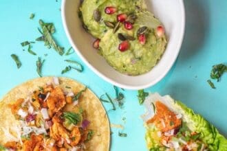 Assorted fresh tacos with vibrant toppings and guacamole.