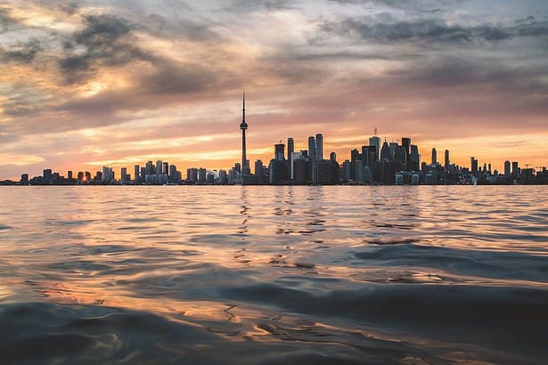 Toronto skyline and lake at sunset.