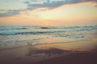 Serene Vancouver beach sunset with gentle waves.