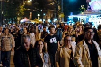 Crowded street in Toronto at night.
