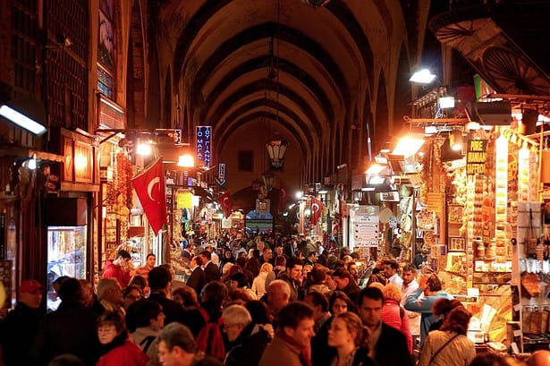 Bustling night market with vibrant stalls and shoppers.